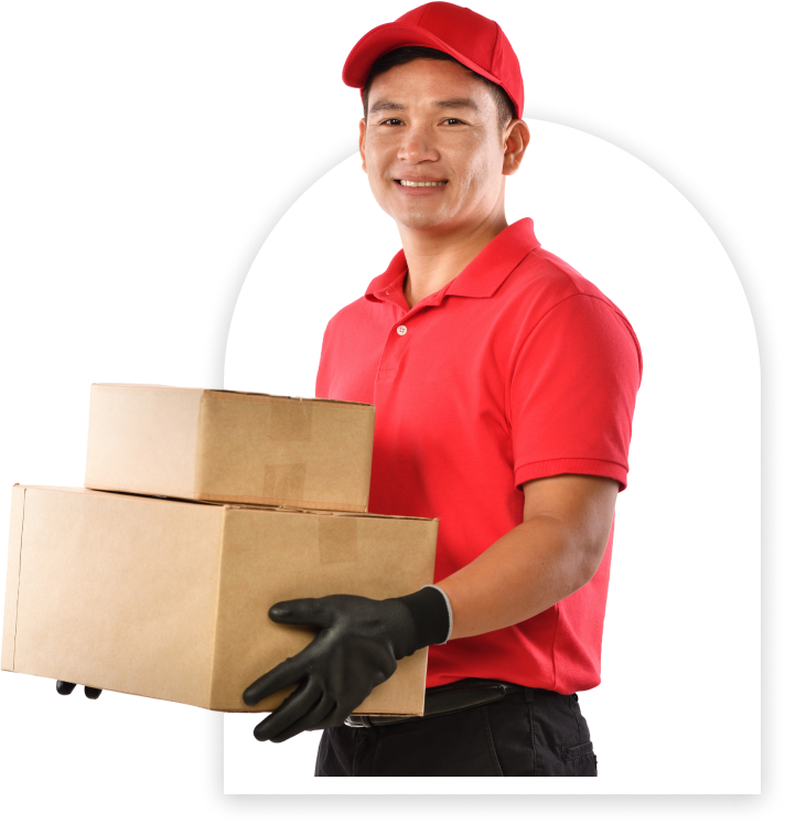 A delivery person in a red uniform and cap holds two cardboard boxes, wearing black gloves.